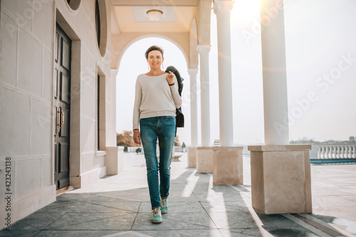 A young woman walks along the embankment