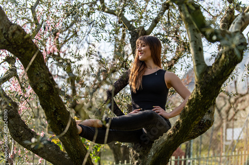 dancer posing above a tree dressed in black