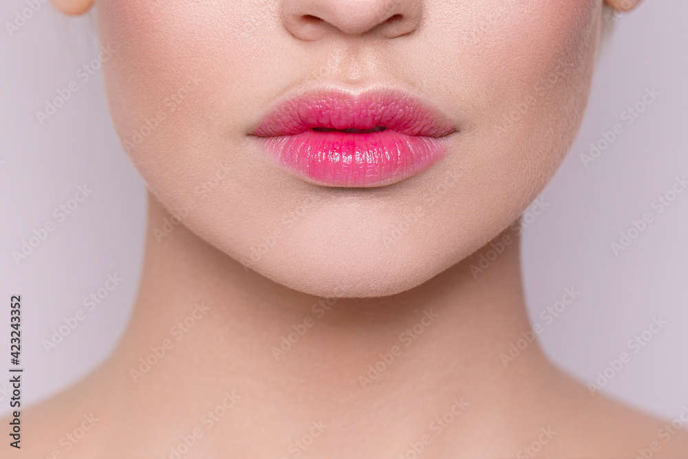 Delicate pink lips close-up. Natural nude lips close-up. Botex. Beautiful natural lips. Fashion. Facial skin care. Lip care. Natural cosmetic. Hyaluronic acid in the lips.