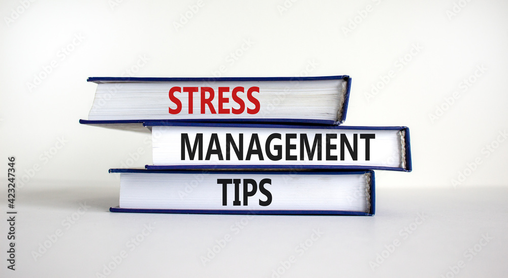 Stress management tips symbol. Books with words 'Stress management tips'. Beautiful white background. Psychological, business and stress management tips concept. Copy space.