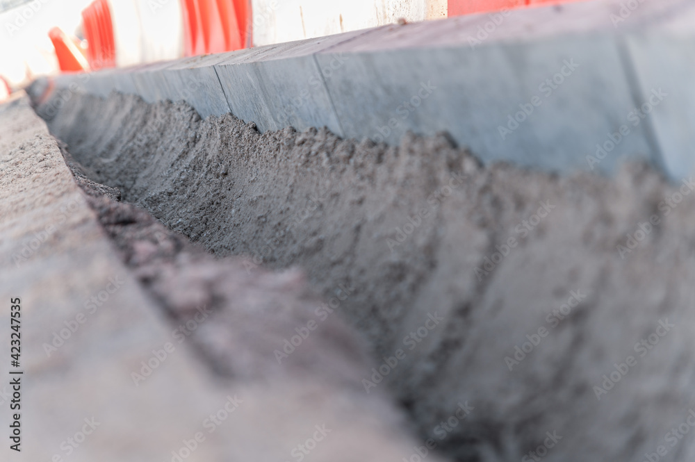 Replacement of curbs along the road and fencing made of plastic water barriers Replacement of curbs along the road and fencing made of plastic water barriers