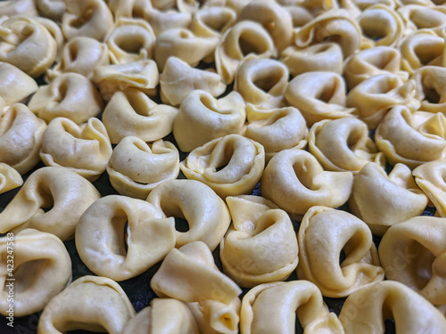 A close up top view shot of raw Tortellini with white mushrooms Texture Food photography