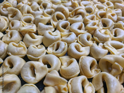 A close up top view shot of raw Tortellini with white mushrooms Texture Food photography