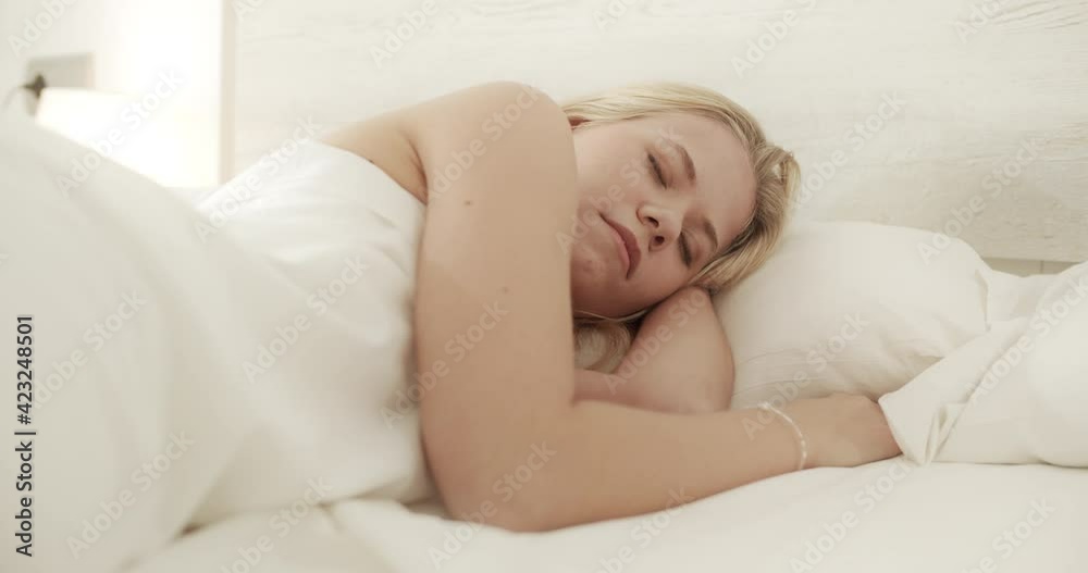 Blonde Young Woman Peacefully Sleeping in Airy Bedroom Blonde Young Woman Peacefully Sleeping in Airy Bedroom