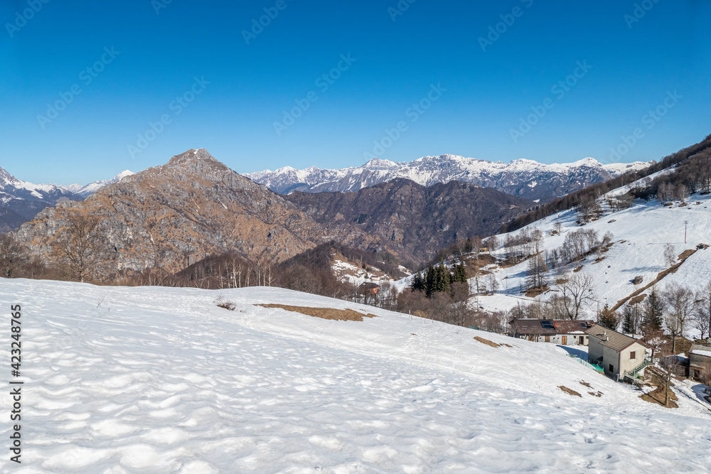 Wide view of the Mount Grigna with snow and blue sky