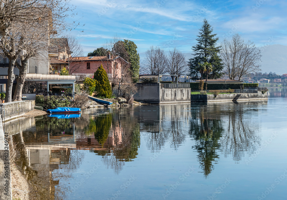 The town of Pusiano is reflected in the water of its lake