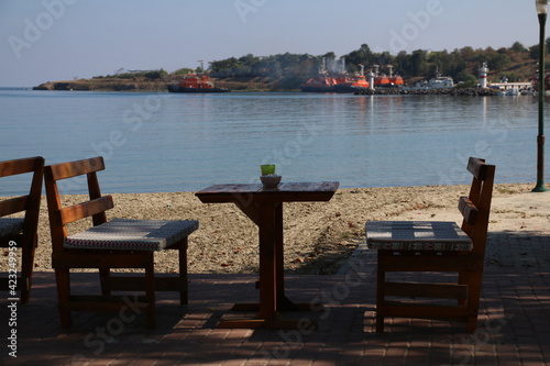 a cafe table on the beach with a sea view. selective focus © Emrah