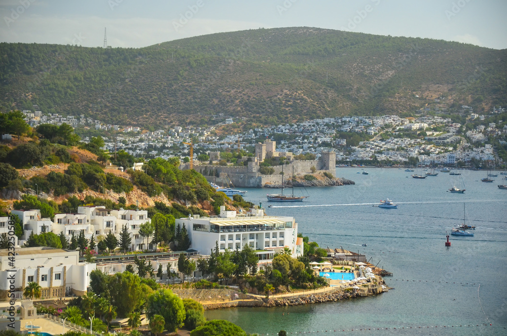 Panoramic View of Aegean sea, traditional white houses marina and Bodrum Castle in Bodrum city of Turkey. Aegean traditional style architecture. Bodrum bay. View from hight