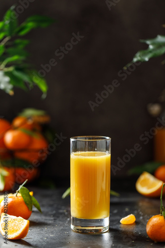 A glass of orange juice on dark background