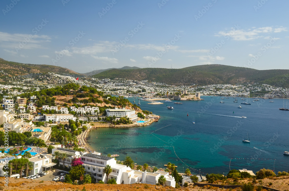 Panoramic View of Aegean sea, traditional white houses marina and Bodrum Castle in Bodrum city of Turkey. Aegean traditional style architecture. Bodrum bay. View from hight