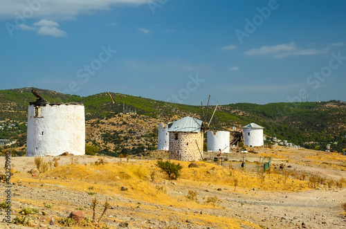 Historical Windmill of Bardakci Cove.  Ruins of white windmill located on the hill top between Gumbet and Bodrum bay. Bodrum, Turkey