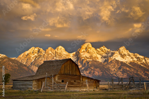 The Moulton Barn on Mormon Row stands before a fiery sunrise on the Teton Mountains in Grand Teton National Park, Wyoming.    