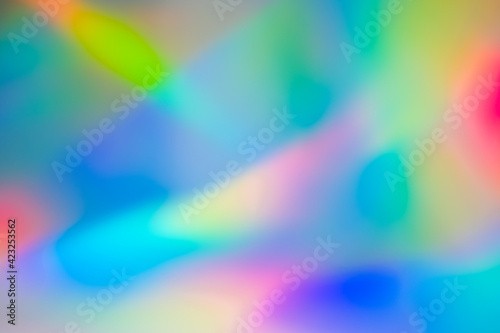 Multi colored background with holographic texture effect. © Christina