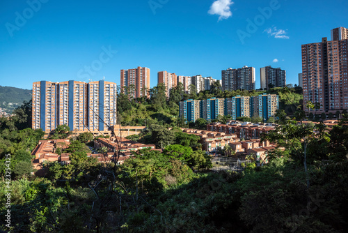 Urban landscape in medellin with buildings, trees and blue sky. photo