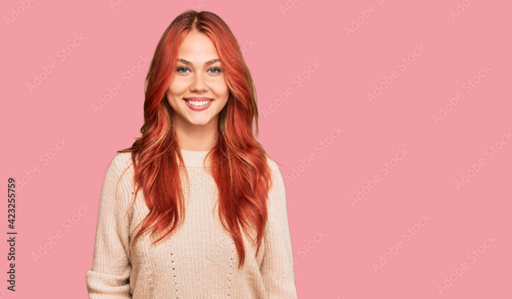 Young redhead woman wearing casual winter sweater with a happy and cool smile on face. lucky person. Young redhead woman wearing casual winter sweater with a happy and cool smile on face. lucky person.