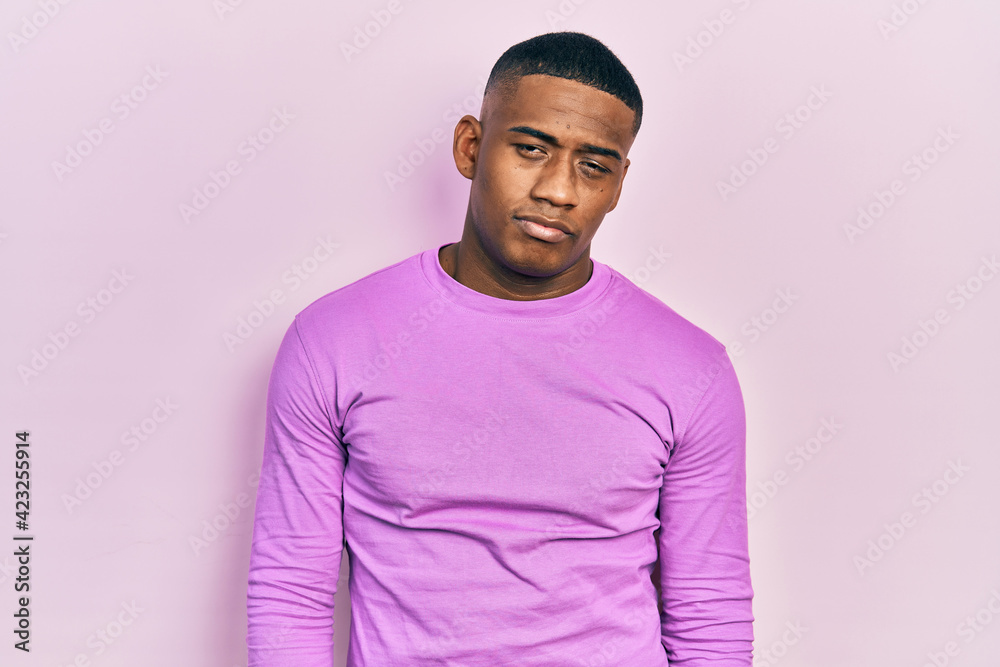 Young black man wearing casual pink sweater looking sleepy and tired, exhausted for fatigue and hangover, lazy eyes in the morning. Young black man wearing casual pink sweater looking sleepy and tired, exhausted for fatigue and hangover, lazy eyes in the morning.