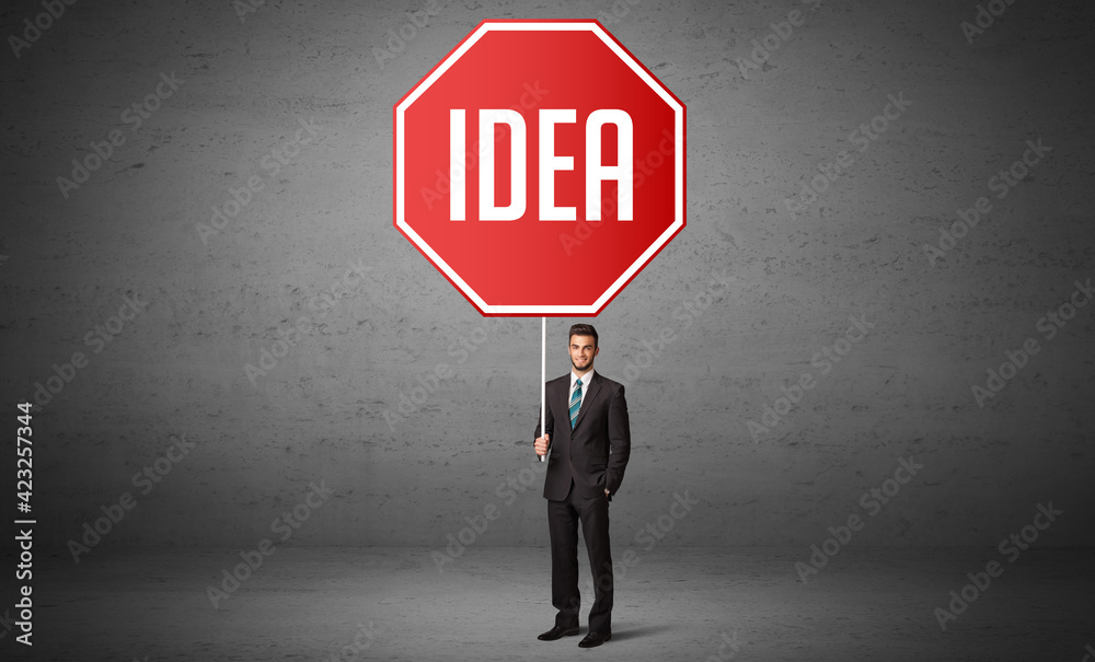Young business person holding road sign Young business person holding road sign