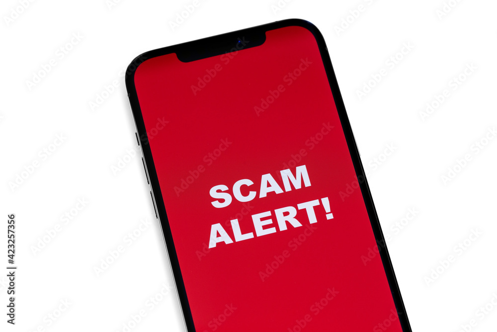 Scam Alert concept on red screen mobile, smartphone closeup on white background Scam Alert concept on red screen mobile, smartphone closeup on white background
