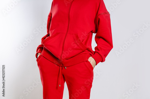 front view of a girl in a red tracksuit on a white background photo