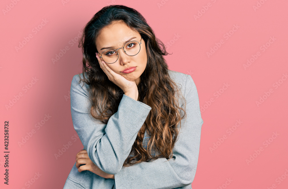 Young hispanic girl wearing business clothes and glasses thinking looking tired and bored with depression problems with crossed arms. Young hispanic girl wearing business clothes and glasses thinking looking tired and bored with depression problems with crossed arms.