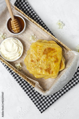 Homemade rghaif or msemen Arab with honey and cream cheese photo