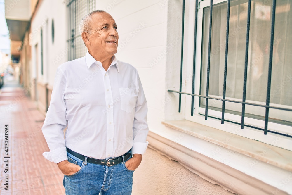 Senior man smiling happy walking at the city. Senior man smiling happy walking at the city.