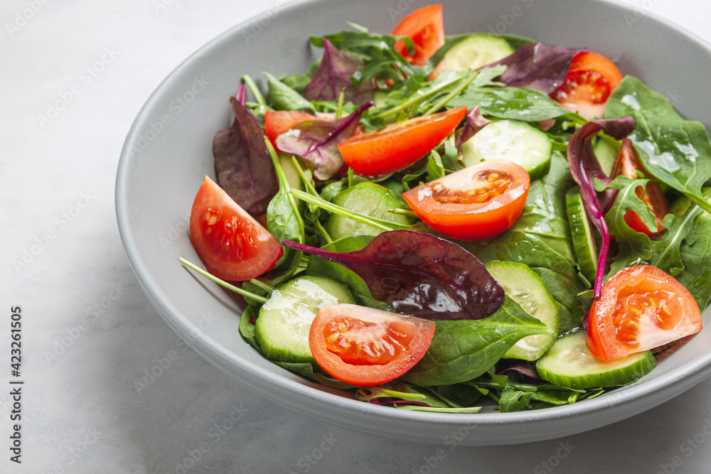 Healthy fresh salad of vegetable cucumber, tomato, spinach, arugula Healthy fresh salad of vegetable cucumber, tomato, spinach, arugula