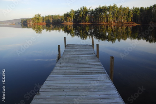 Enjoying the view of the morning reflections from the dock, Bow Lake, Strafford, New Hampshire     photo