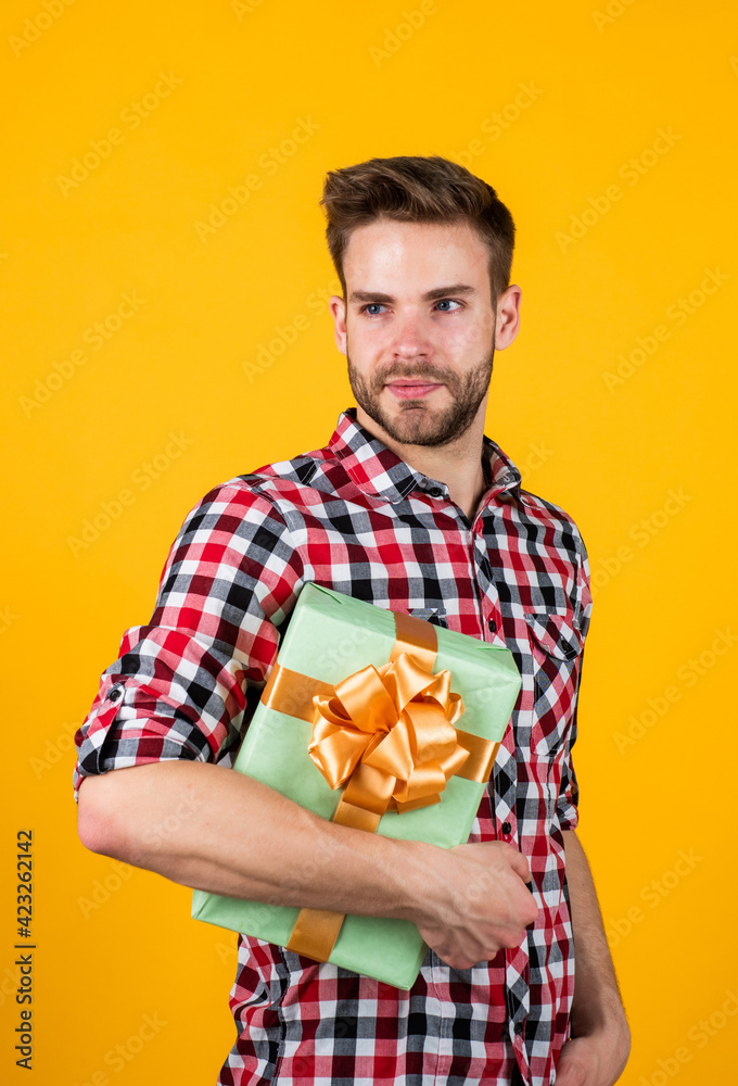 male with fashionable groomed hair and beard hold box, present male with fashionable groomed hair and beard hold box, present