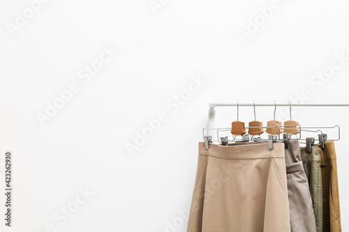 Beige clothes on a hanger on a white background