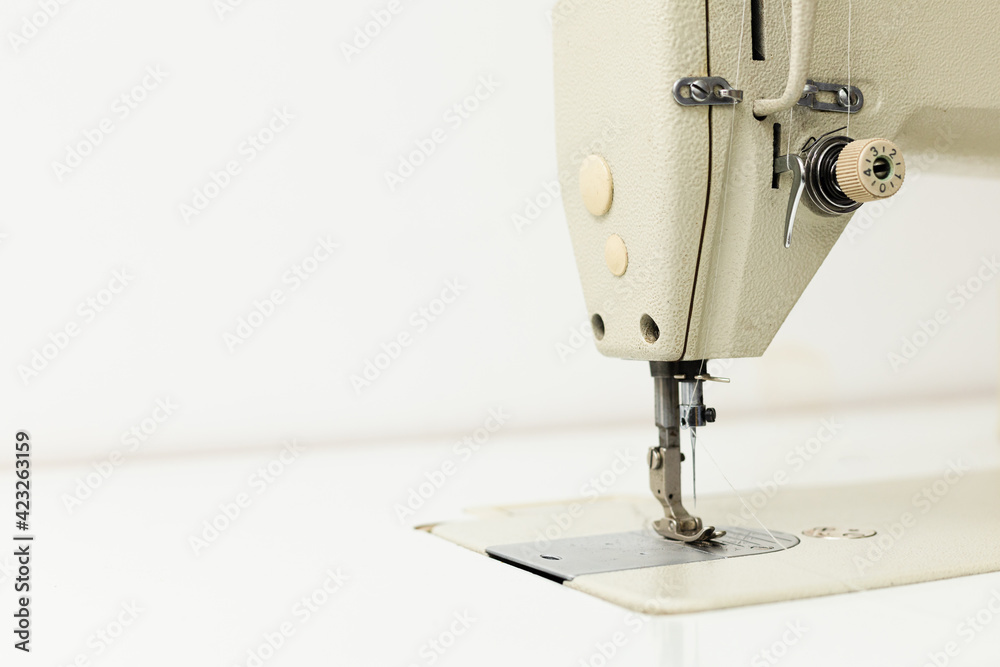 Industrial sewing machine on a white background