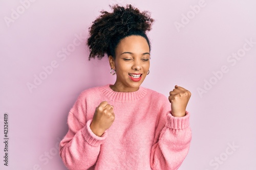 Young african american girl wearing casual clothes celebrating surprised and amazed for success with arms raised and eyes closed