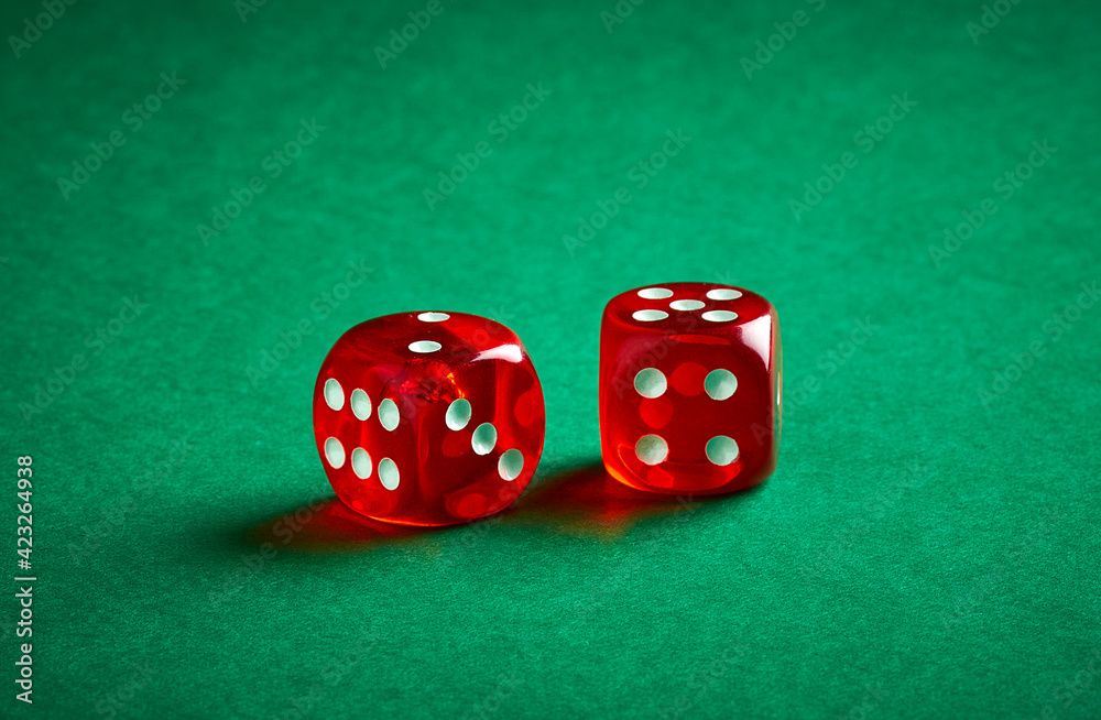 Two red dices on green casino table background Two red dices on green casino table background