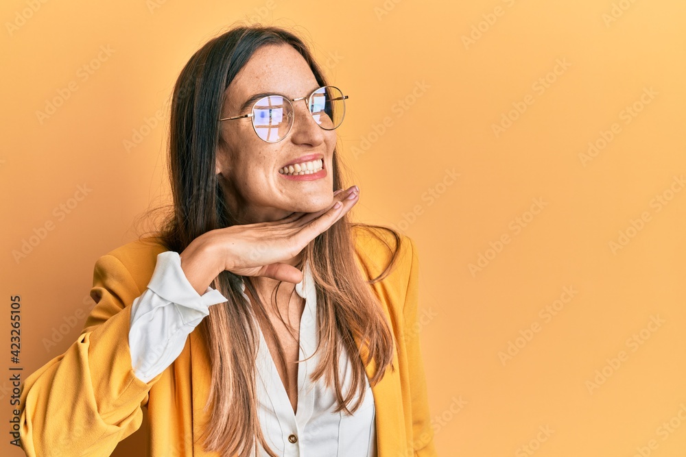 Young beautiful woman wearing business style and glasses cutting throat with hand as knife, threaten aggression with furious violence