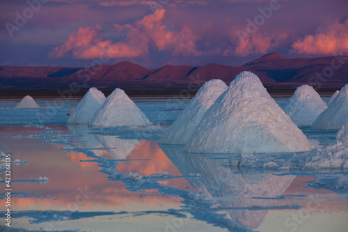 Pyramids of salt dry on the edge of the Salar de Uyuni on Bolivia's Altiplano at sunset.   photo