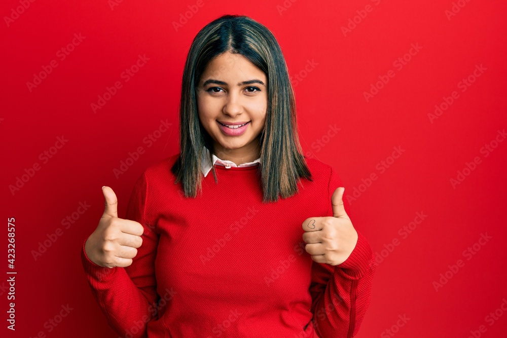 Young latin woman wearing casual clothes success sign doing positive gesture with hand, thumbs up smiling and happy. cheerful expression and winner gesture. Young latin woman wearing casual clothes success sign doing positive gesture with hand, thumbs up smiling and happy. cheerful expression and winner gesture.
