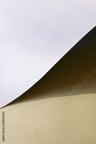 Macro image of grey and yellow paper with shadow effect and selective focus.