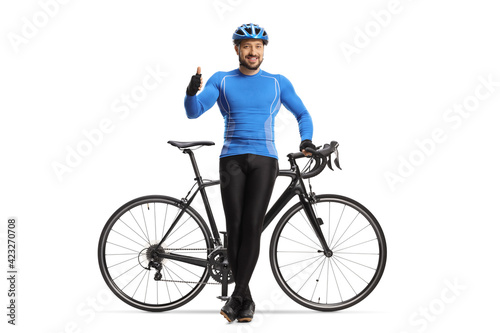 Male cyclist sitting on a bicycle and showing thumbs up