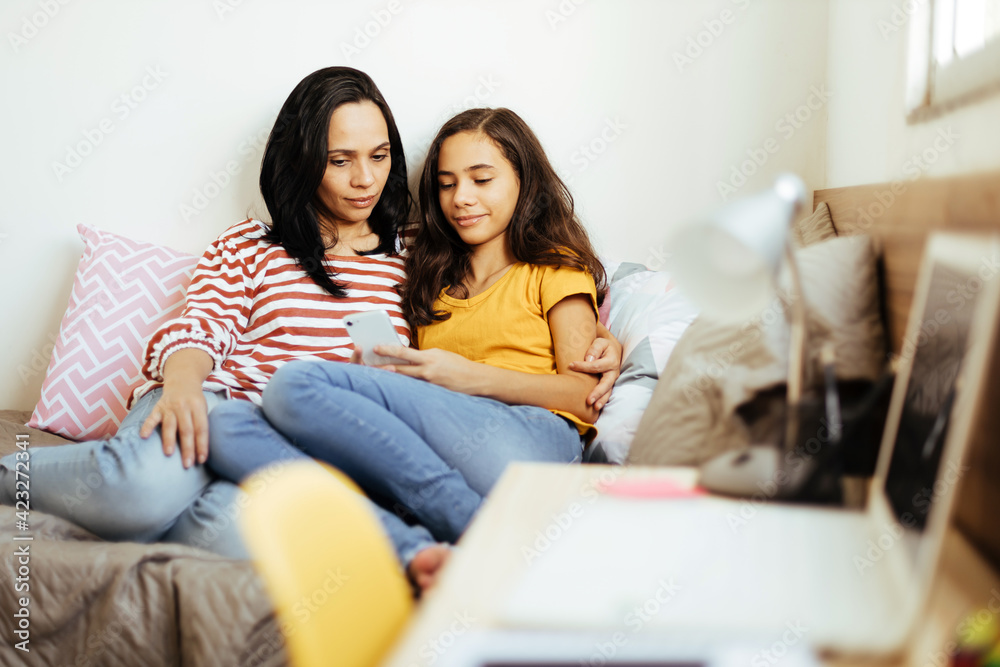 Single parenthood. Mother and daughter spending time together at home. Single parenthood. Mother and daughter spending time together at home.