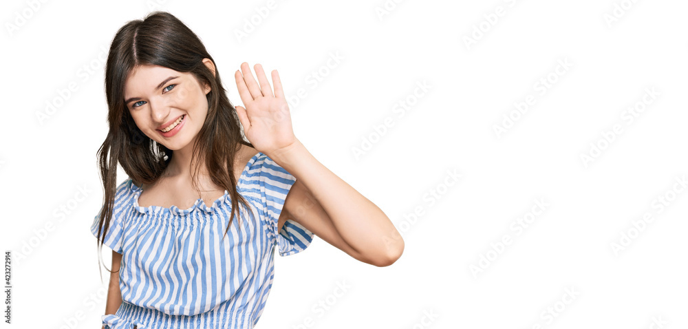 Young beautiful caucasian girl wearing casual clothes waiving saying hello happy and smiling, friendly welcome gesture