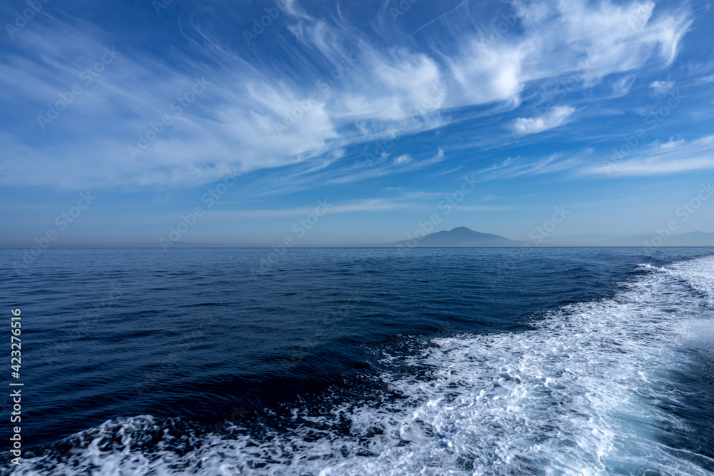 Sailing on the sea, in the background the island of Ischia