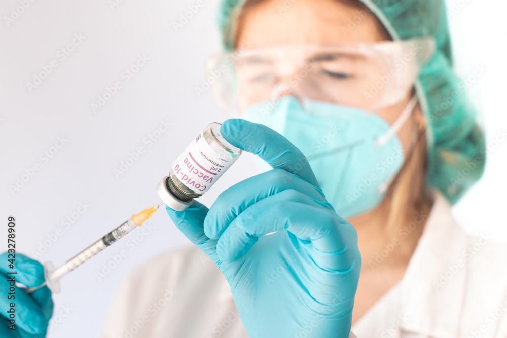 Nurse loading a syringe with Covid-19 vaccine. Pandemic concept. Selective focus. Nurse loading a syringe with Covid-19 vaccine. Pandemic concept. Selective focus.
