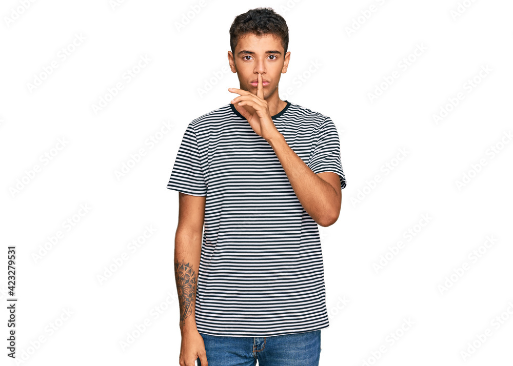 Young handsome african american man wearing casual clothes asking to be quiet with finger on lips. silence and secret concept. Young handsome african american man wearing casual clothes asking to be quiet with finger on lips. silence and secret concept.