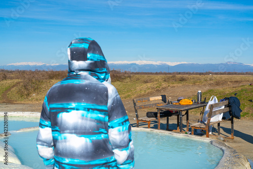 a man stands near a sulfur spring