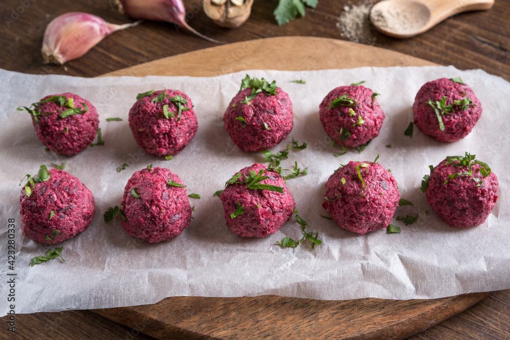 Georgian beetroot phali or pkhali with walnuts, garlic and spices on wooden background.