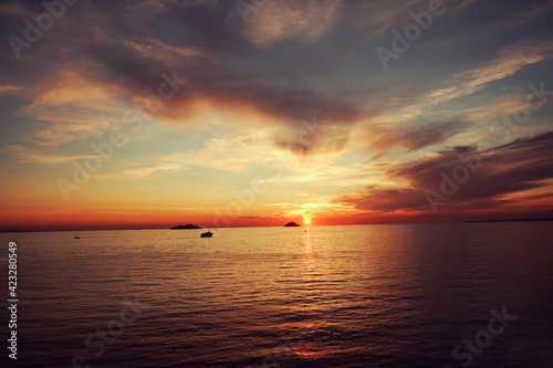 Natural heart shaped frame with clouds and backlight. lovely island at far and a little boat is sailing. Peaceful   mind mindcleansing seascape.