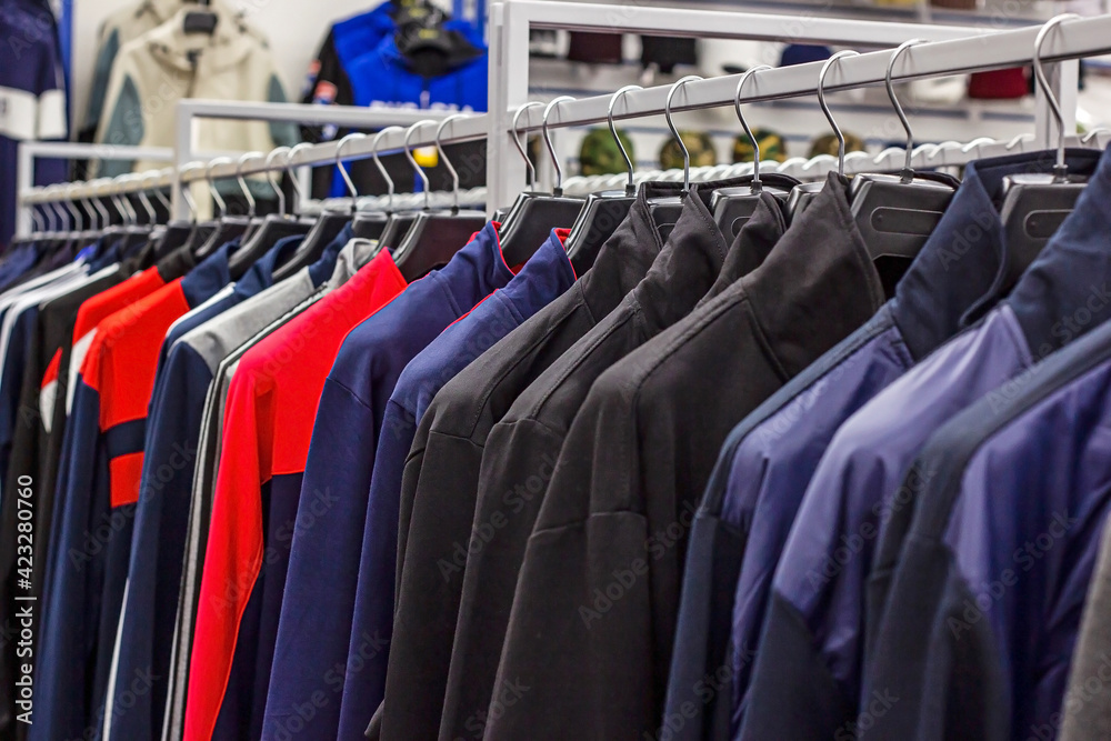 Different casual clothes hanging in the retail clothing store. Different casual clothes hanging in the retail clothing store.
