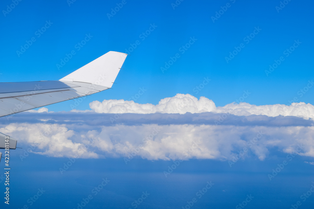 wing of an airplane in the cotton clouds wing of an airplane in the cotton clouds