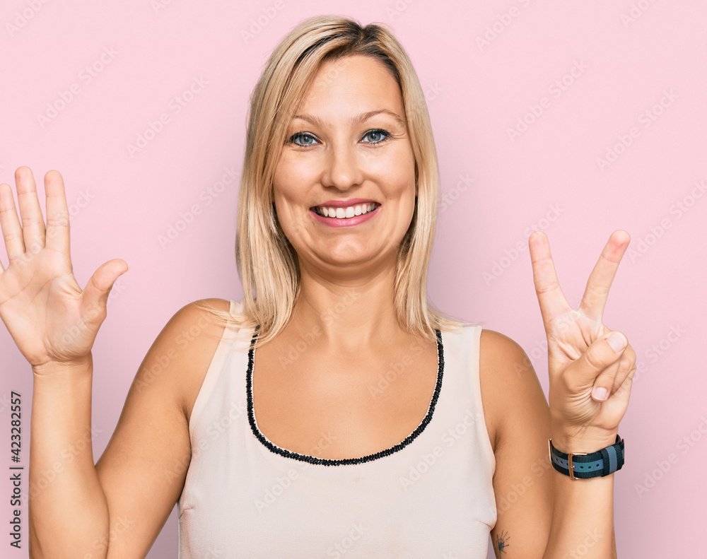 Middle age caucasian woman wearing casual clothes showing and pointing up with fingers number seven while smiling confident and happy. Middle age caucasian woman wearing casual clothes showing and pointing up with fingers number seven while smiling confident and happy.