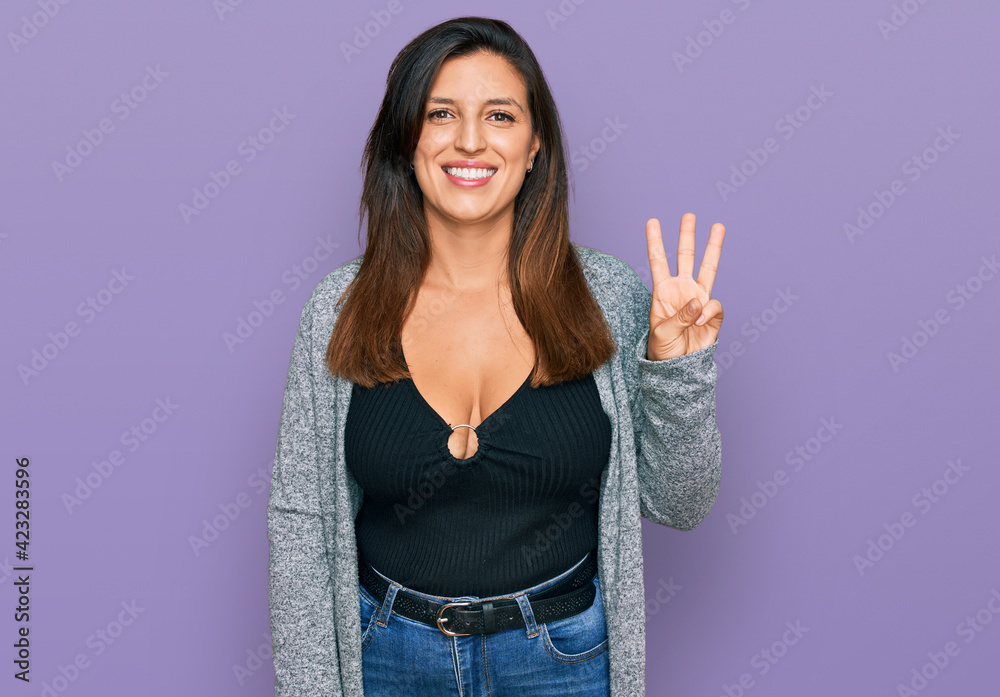 Beautiful hispanic woman wearing casual clothes showing and pointing up with fingers number three while smiling confident and happy. Beautiful hispanic woman wearing casual clothes showing and pointing up with fingers number three while smiling confident and happy.